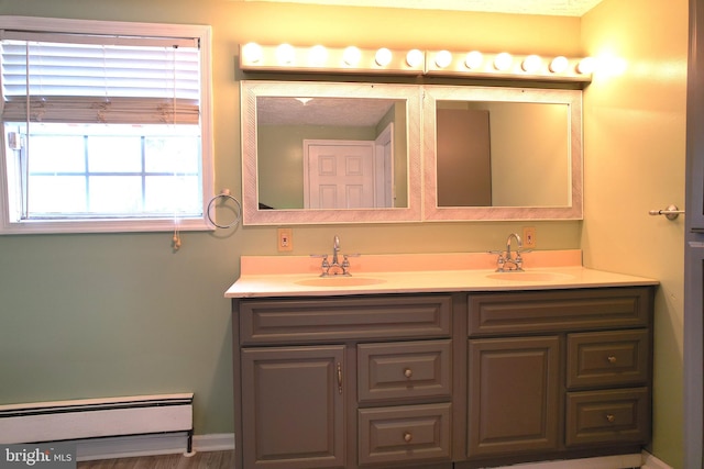 bathroom with vanity, hardwood / wood-style flooring, and a baseboard radiator