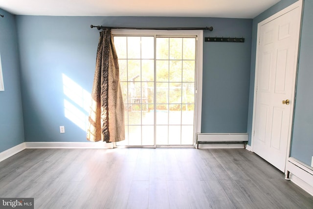 2810 Panther Rd, Vineland, NJ 08361 - interior space featuring a baseboard heating unit, baseboards, plenty of natural light, and wood finished floors