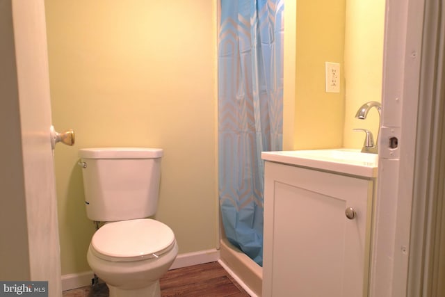 bathroom with toilet, vanity, wood-type flooring, and a shower with shower curtain