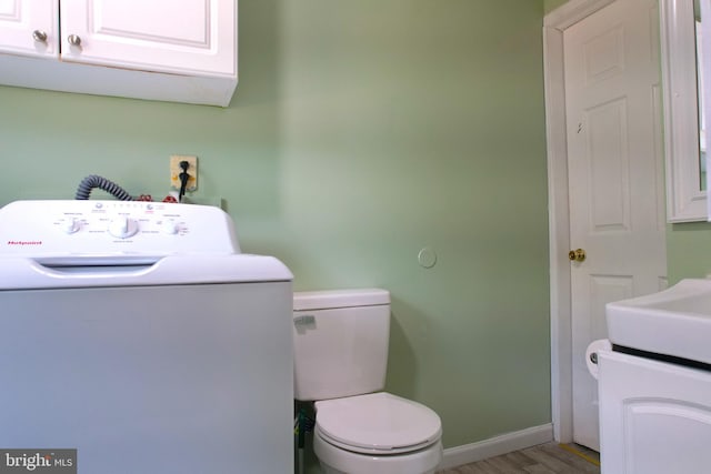 laundry room with washer / dryer and light wood-type flooring