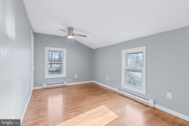 empty room featuring a baseboard heating unit, light hardwood / wood-style flooring, and ceiling fan