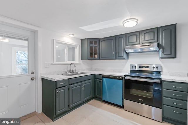 kitchen featuring light tile patterned flooring, stainless steel appliances, and sink