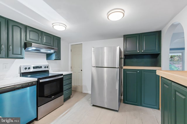 kitchen with stainless steel appliances and green cabinets