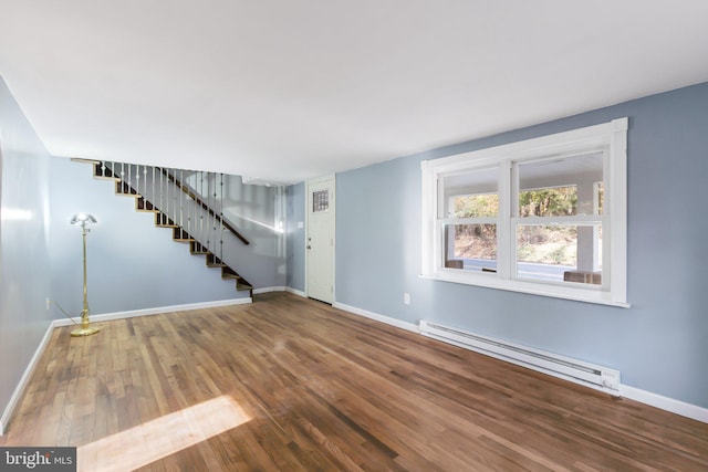 unfurnished room with a baseboard radiator and hardwood / wood-style floors