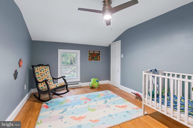 bedroom with ceiling fan, wood-type flooring, and vaulted ceiling