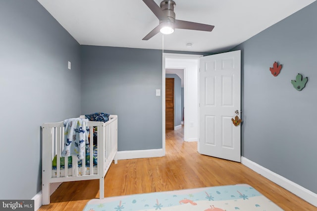 bedroom with ceiling fan and hardwood / wood-style flooring