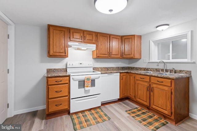 kitchen with sink, light hardwood / wood-style flooring, and white appliances