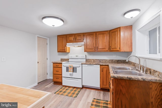 kitchen with sink, light wood-type flooring, and white appliances