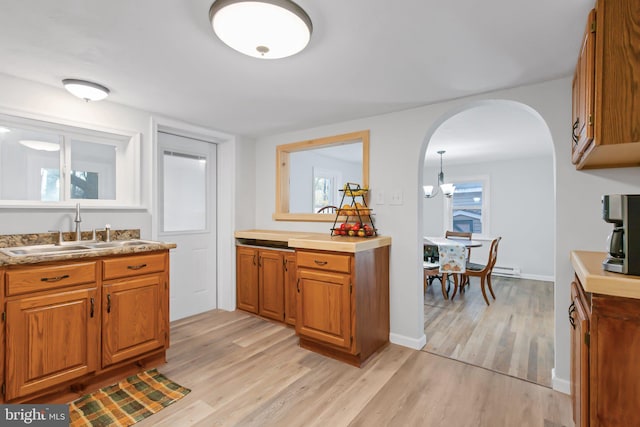 kitchen with a wealth of natural light, sink, and light wood-type flooring