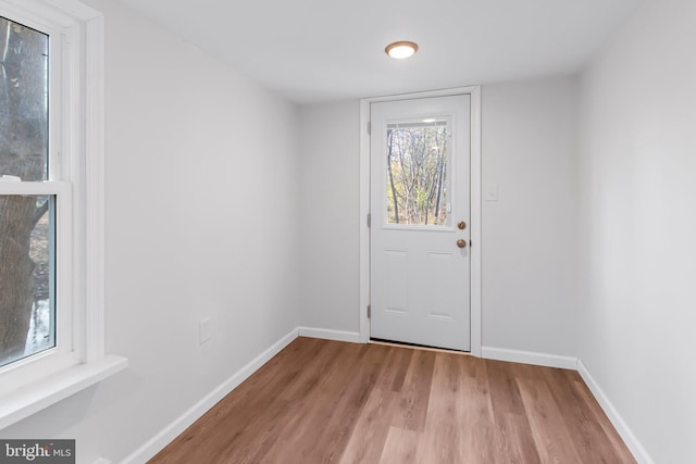 doorway to outside with light wood-type flooring