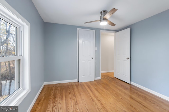 unfurnished bedroom featuring ceiling fan and light wood-type flooring