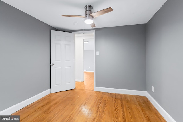 empty room featuring hardwood / wood-style floors and ceiling fan