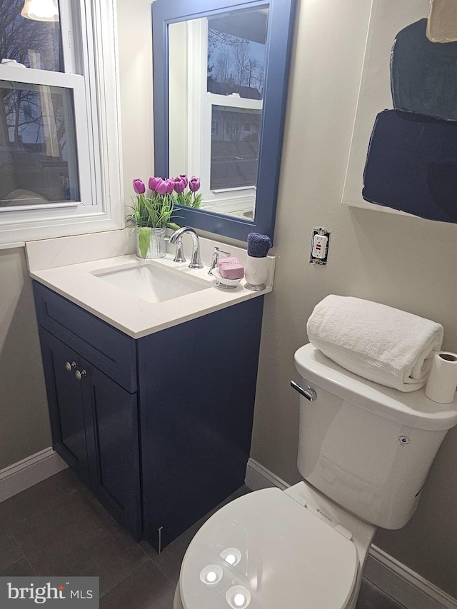 bathroom with tile patterned floors, vanity, and toilet