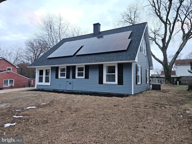 view of front of house featuring cooling unit and solar panels