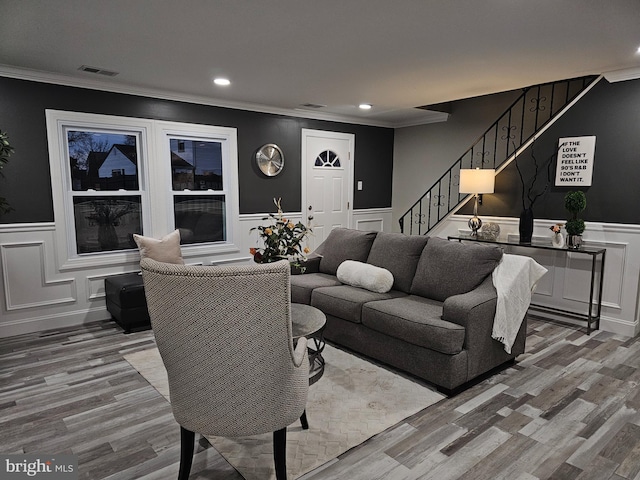 living room with crown molding and wood-type flooring