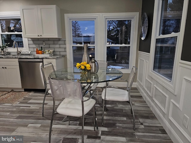 dining area featuring dark wood-type flooring and sink