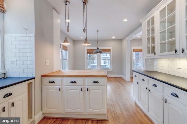 kitchen featuring white cabinets, a wealth of natural light, and light hardwood / wood-style floors