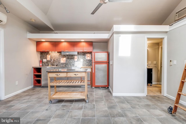 kitchen featuring tile patterned flooring, lofted ceiling, and tasteful backsplash