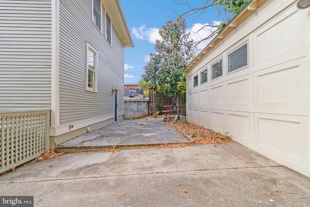 view of home's exterior with a garage and a patio area