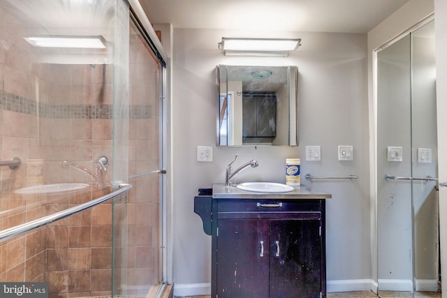 bathroom featuring an enclosed shower and vanity