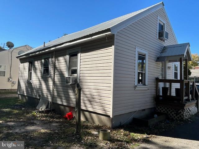 view of side of property with cooling unit