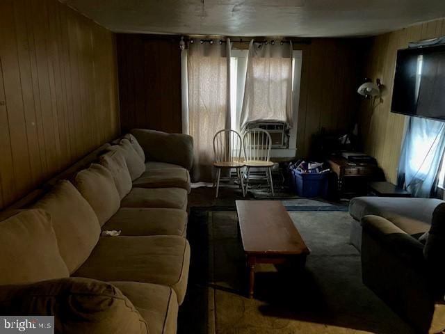 living room featuring wood walls and cooling unit