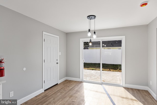 unfurnished dining area featuring hardwood / wood-style flooring