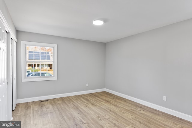 empty room with light hardwood / wood-style flooring