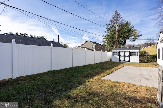 view of yard with a patio area and a storage shed