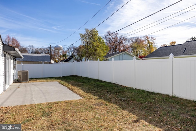 view of yard with a patio and central air condition unit