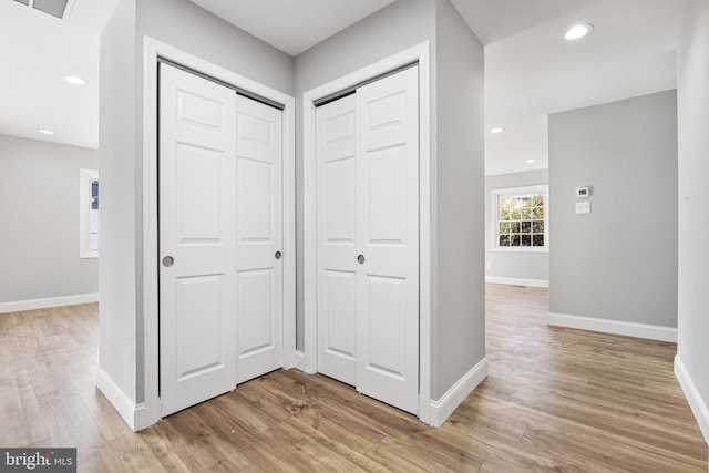 corridor with light hardwood / wood-style flooring