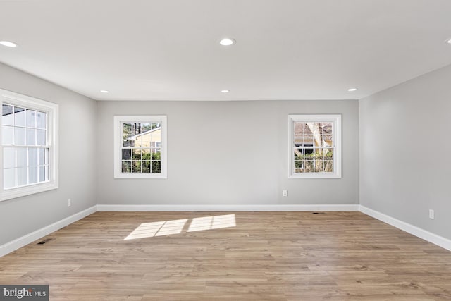 unfurnished room with light hardwood / wood-style flooring