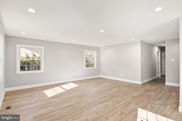 empty room with light hardwood / wood-style floors