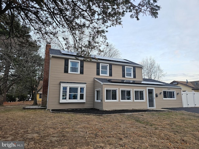 54 Shelbourne Ln, Willingboro, NJ 08046 - rear view of property featuring a chimney and solar panels