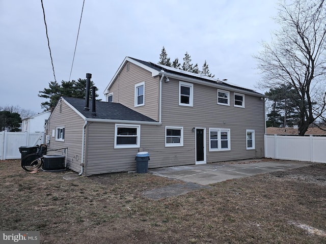 rear view of property featuring central air condition unit and a patio