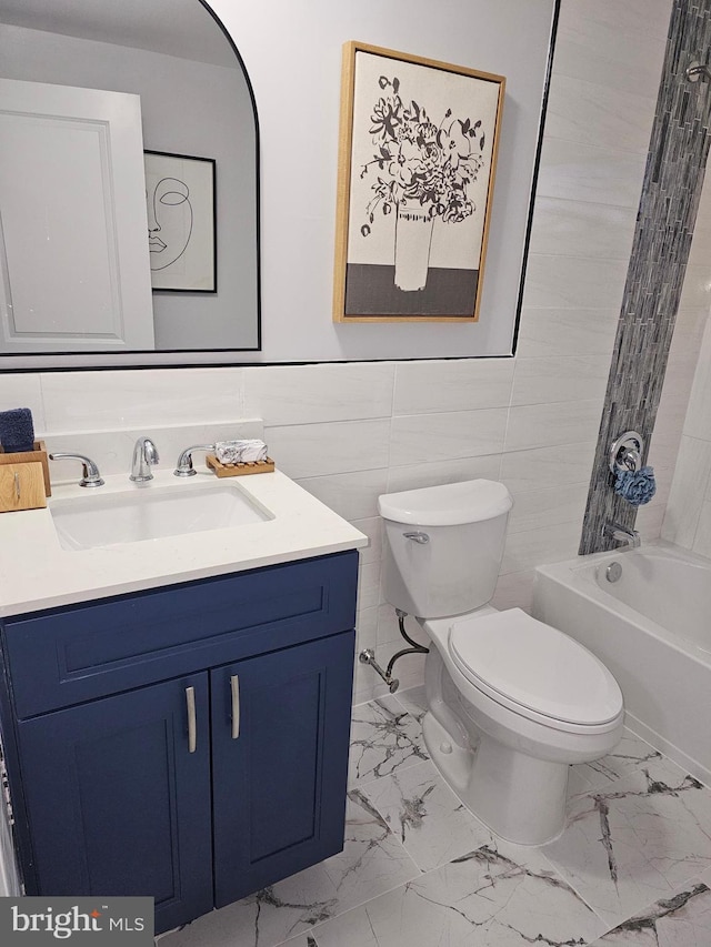 full bathroom featuring shower / bathing tub combination, vanity, toilet, and tile walls