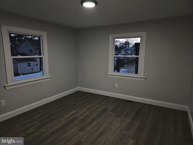 spare room featuring dark hardwood / wood-style flooring