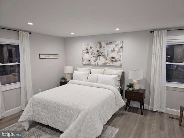 bedroom with dark hardwood / wood-style floors