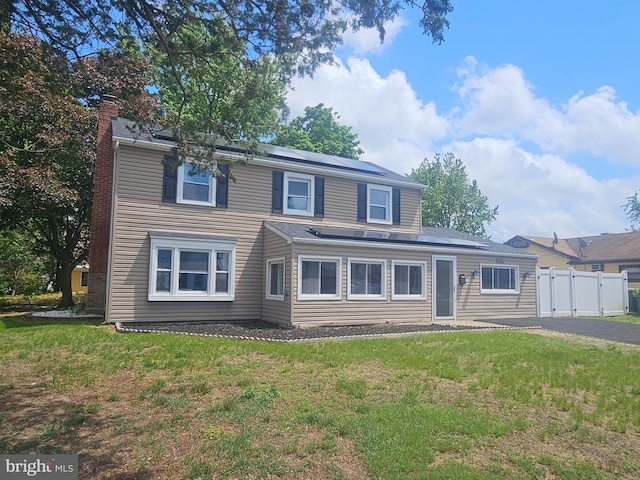 54 Shelbourne Ln, Willingboro, NJ 08046 - traditional home featuring solar panels, a chimney, and driveway