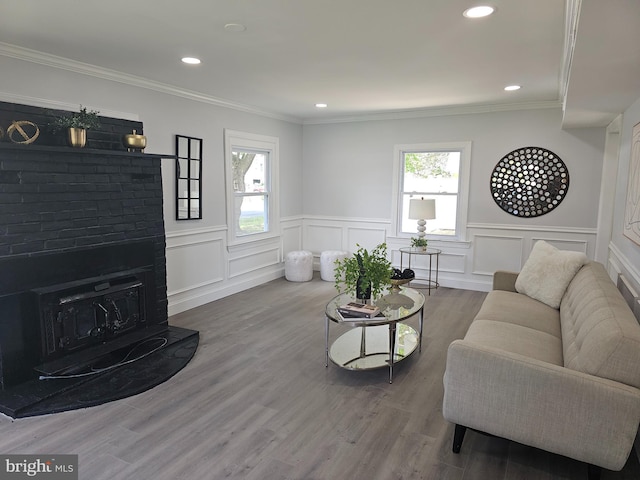 54 Shelbourne Ln, Willingboro, NJ 08046 - living area featuring a brick fireplace, a wainscoted wall, wood finished floors, a decorative wall, and recessed lighting
