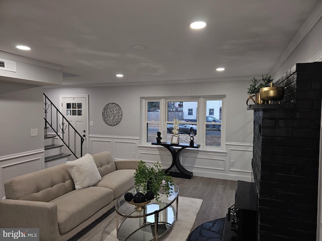 living room featuring hardwood / wood-style floors and crown molding