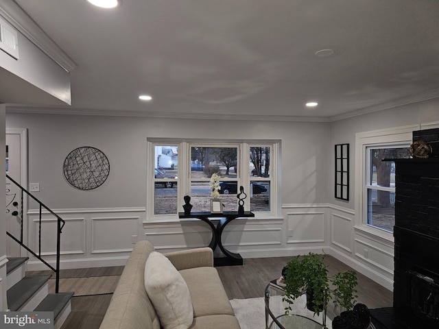 living room featuring ornamental molding and dark wood-type flooring