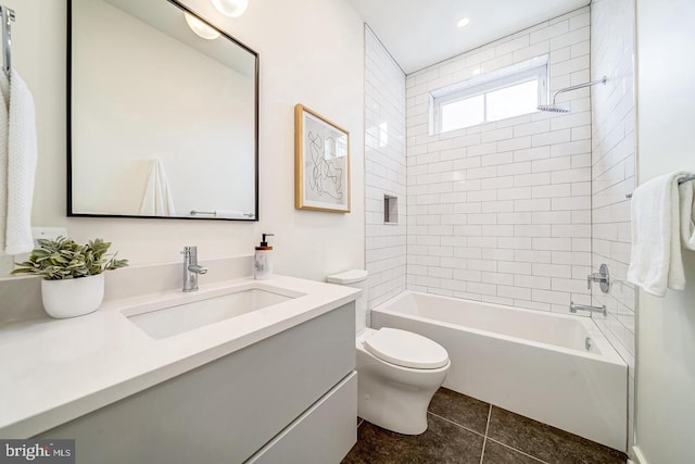 full bathroom featuring vanity, tiled shower / bath combo, toilet, and tile patterned flooring