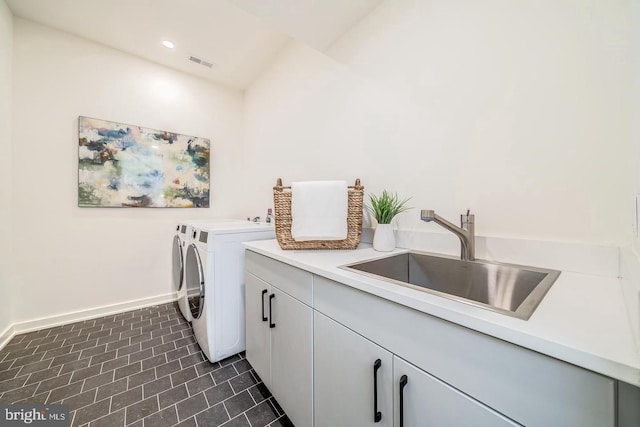 laundry room with cabinets, sink, and washer and clothes dryer