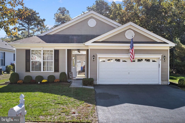 view of front of home featuring a front yard and a garage