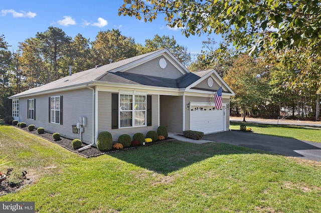 view of front of house with a front yard and a garage