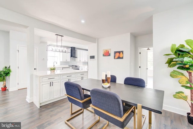 dining area with dark hardwood / wood-style flooring and an inviting chandelier