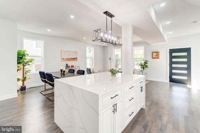 kitchen with white cabinets, baseboards, light stone countertops, recessed lighting, and dark wood finished floors