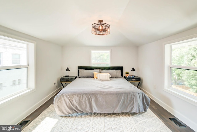 bedroom featuring light wood-type flooring and vaulted ceiling