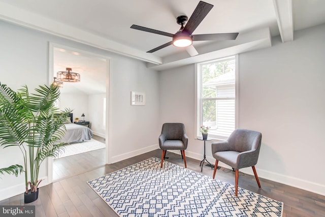 sitting room with baseboards, a ceiling fan, and dark wood-type flooring